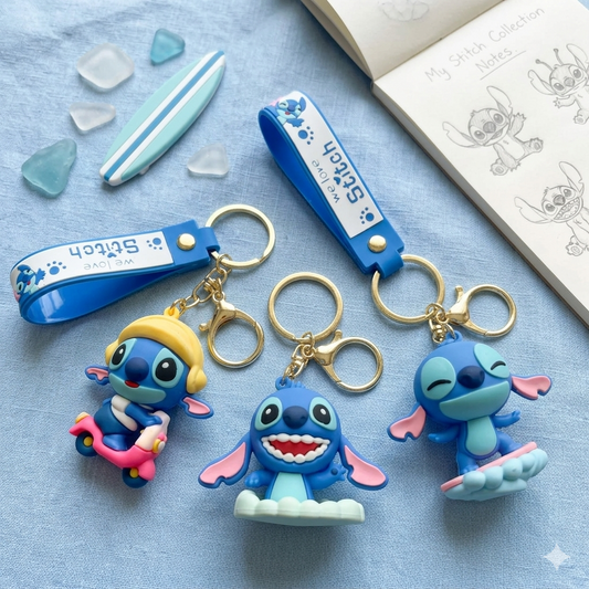Three blue cartoon character keychains on a light blue surface with a white box in the background.
